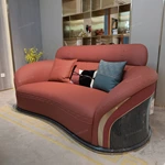Curved Terracotta Leather Sofa and Blue Accent Chair Set with High-Gloss Wood Details